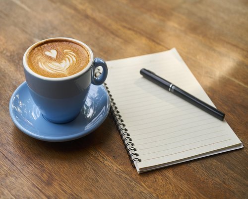 Person taking a relaxing coffee break in a bright cafe